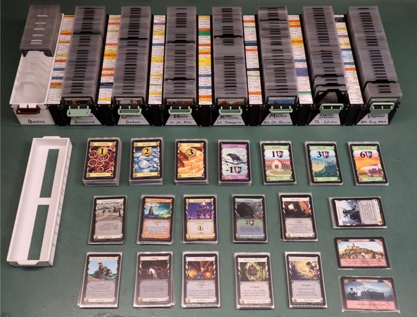 An example of how the open boxes might look, set up for a game. Trashed cards go into the white lid.