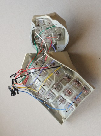 Fully connected columns and rows of keys on the right-hand side of a Concertina v0.7.0, all terminated in crimped M20 connectors for an MCU, for rows (black, red) and columns (other colours of wire). This is a complete key-cluster subassembly, though it still has no caps.