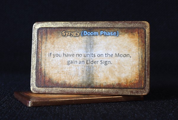 This printed and hand-tinted Spellbook displays a house rule published by Matthew Folger on BoardGameGeek. Unlike the faction’s standard Spellbooks, I painted this one in the gold that is the faction’s true colour.